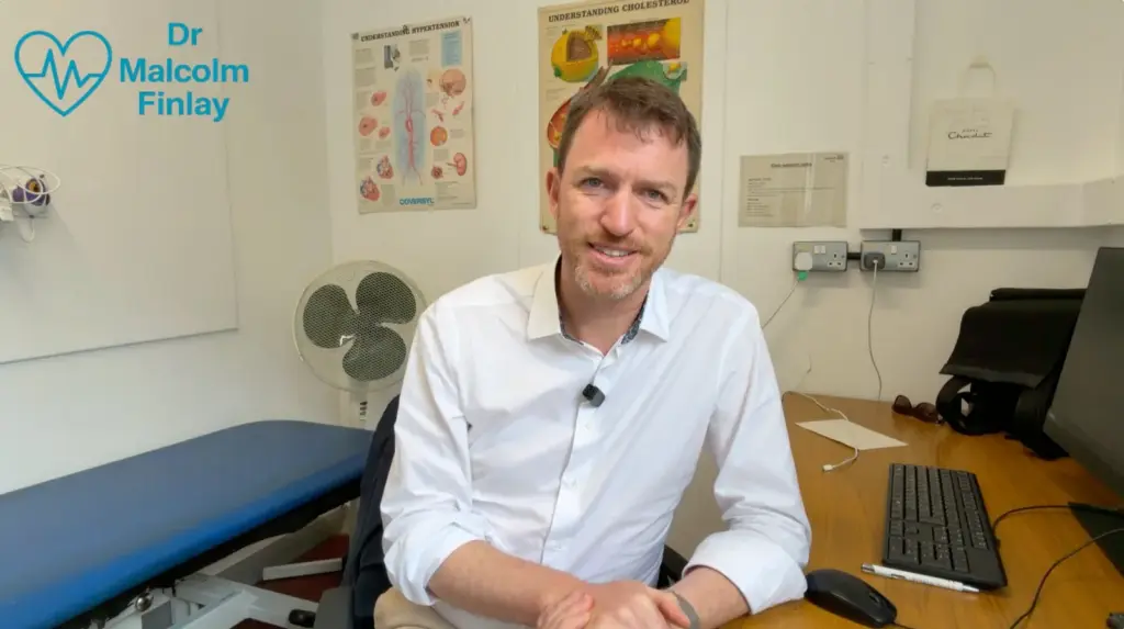 Dr Malcolm Finlay speaking to camera in his consulting room