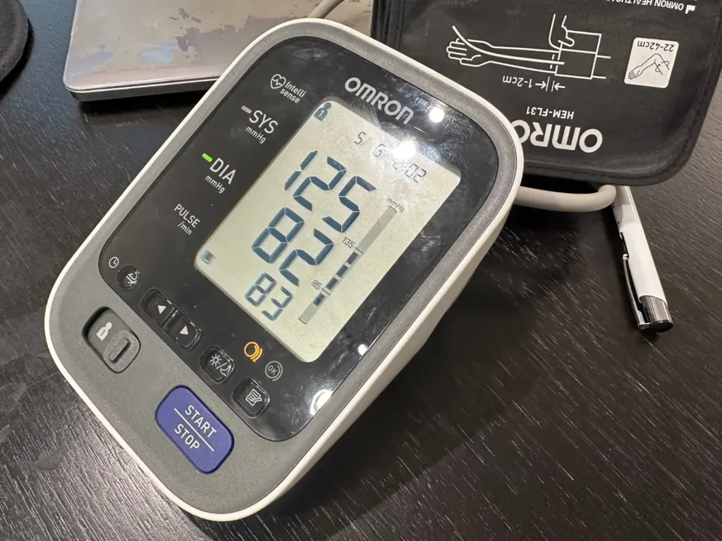 Home blood pressure monitor showing a reading